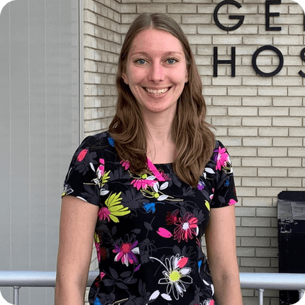 Madison, a diagnostic medical sonographer, stands outside of flin flon general hospital